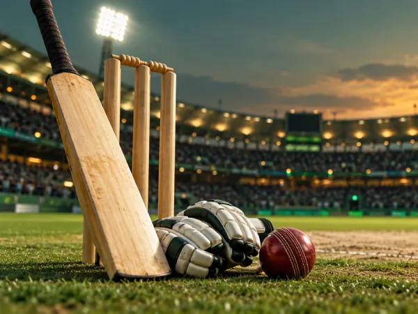 k1game + Cricket bat, red ball, batting gloves and stumps beside a floodlit pitch
