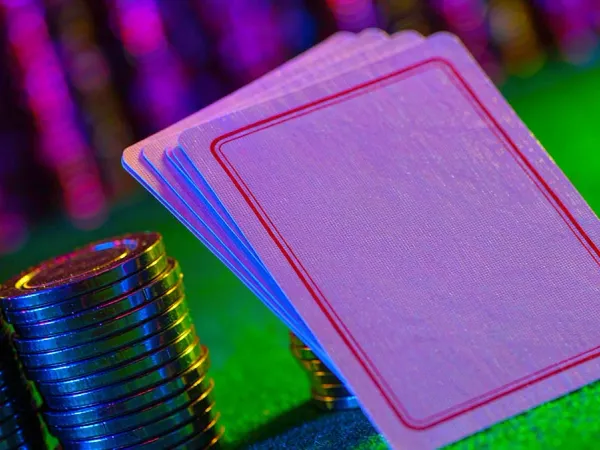 k1game + Face-down playing cards beside colourful casino chips